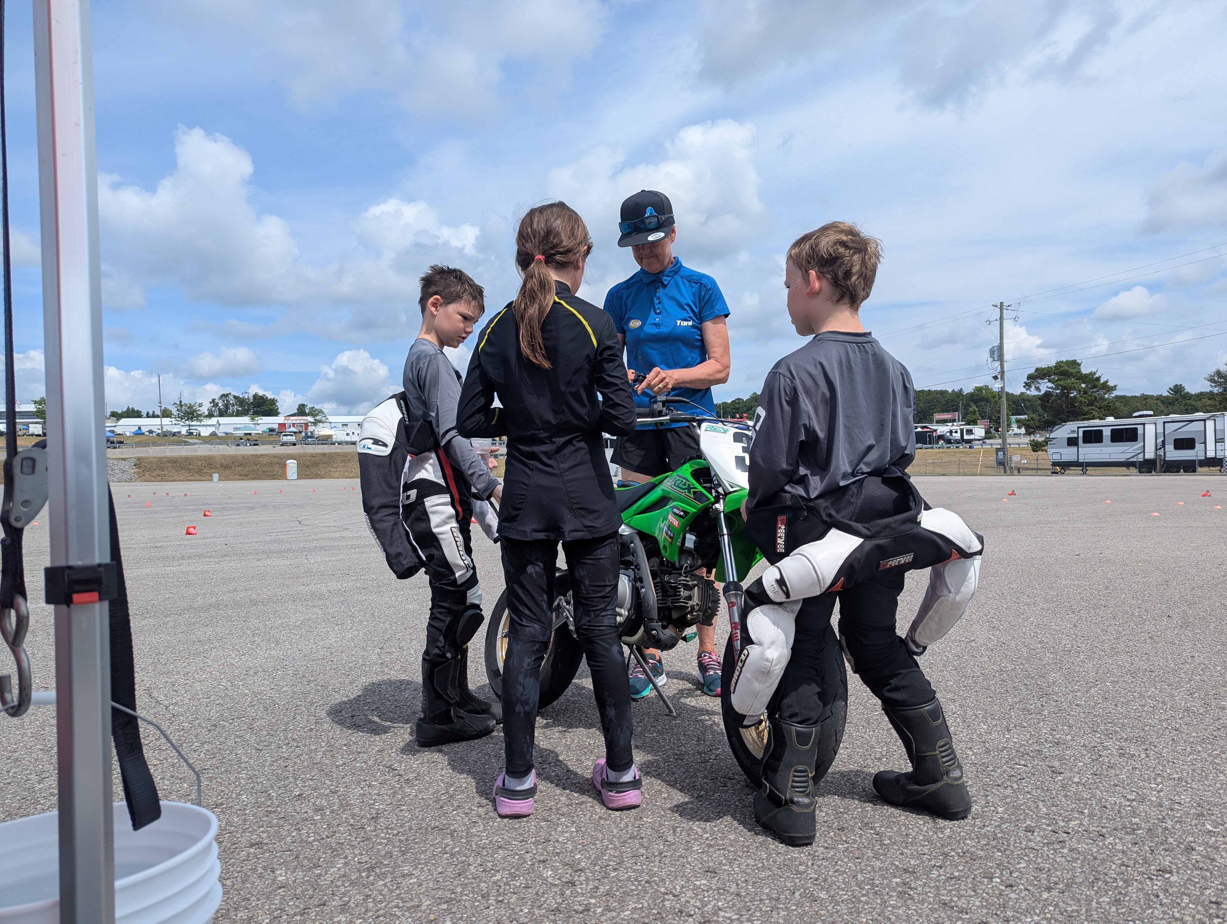 Riders and coaches regrouping between drills at a Super Sonic school day